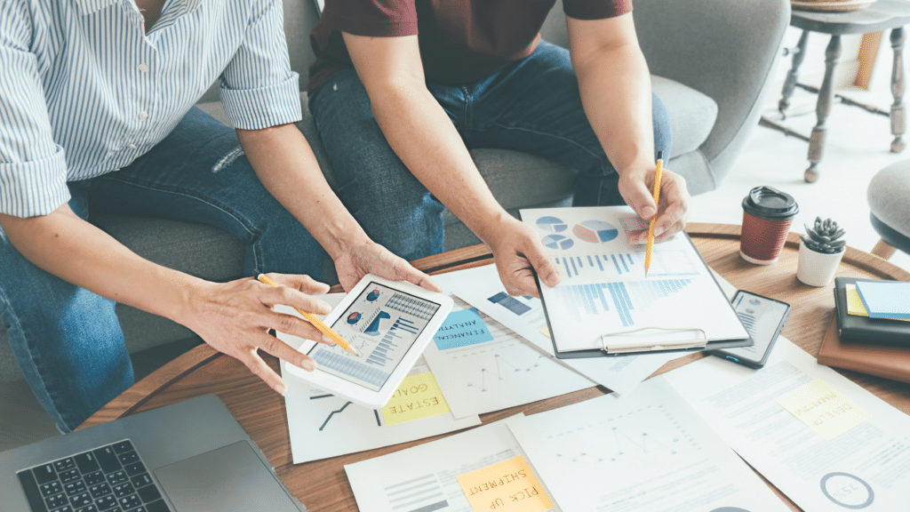 Team reviewing financial charts and reports to measure business performance and profitability