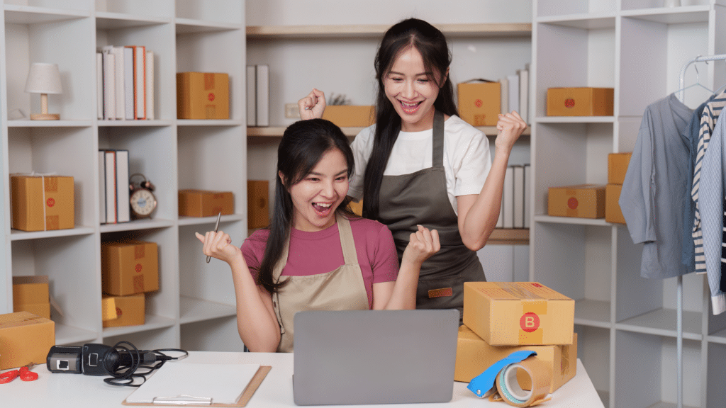 E-commerce business owners reviewing sales data to calculate their break-even point