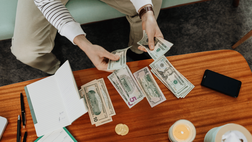 Person counting cash for quarterly profit distribution