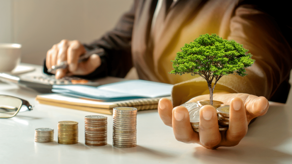 Hand holding coins with small tree symbolizing profit growth