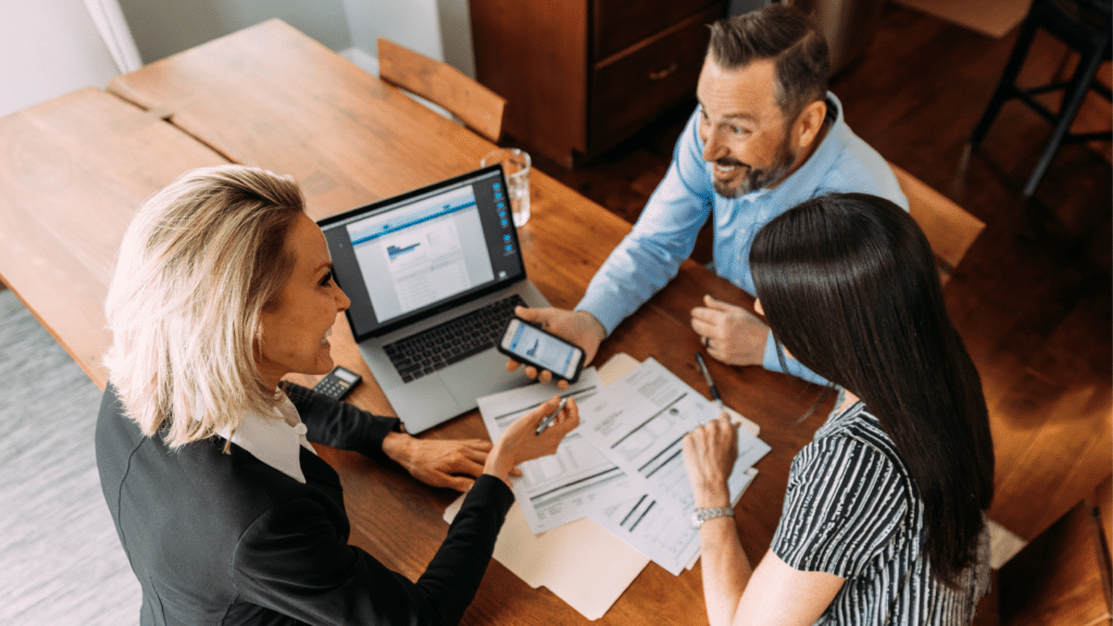 Business owners reviewing financial documents and planning bank account strategies 