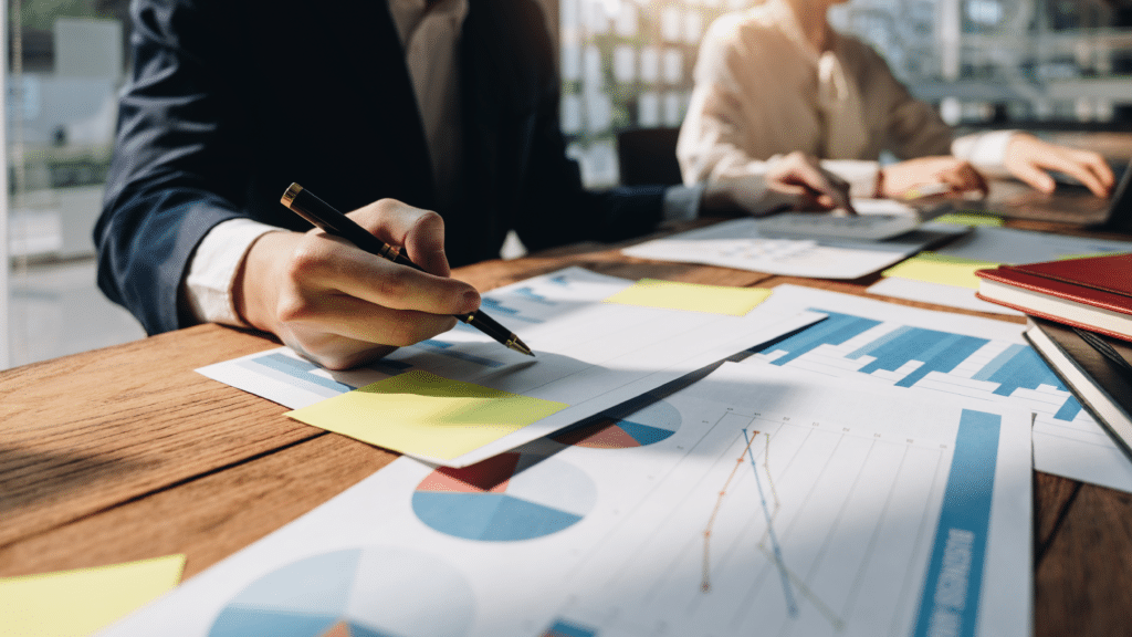 Professional analysing inventory reports and business data for seasonal stock planning and forecasting