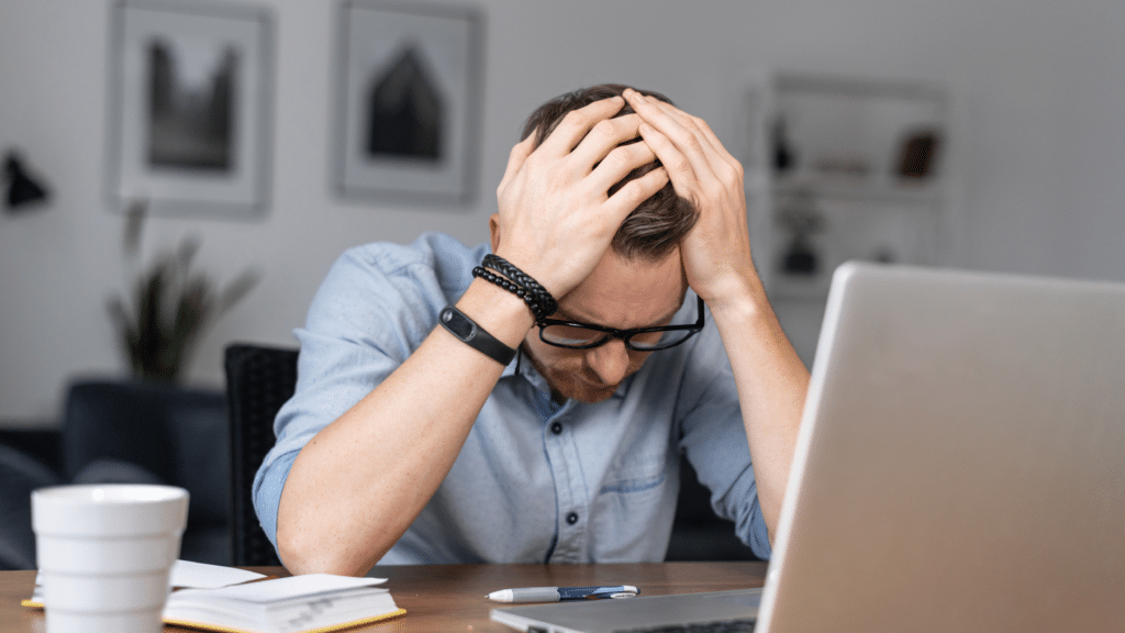 Business owner feeling stressed while managing accounting tasks and avoiding costly bookkeeping mistakes