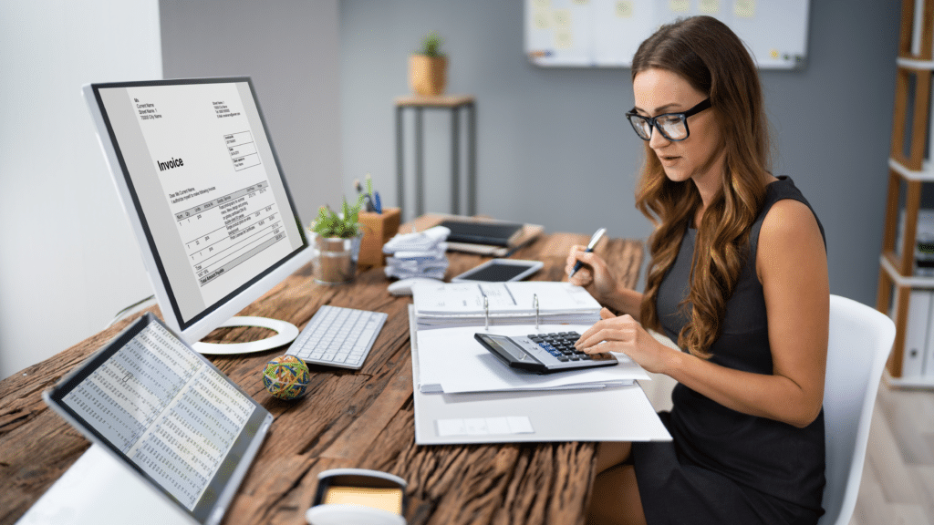 Professional reviewing invoices and financial records to identify bookkeeping mistakes affecting business finances