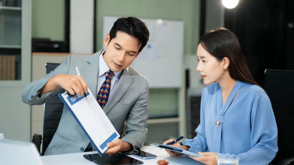 Professionals reviewing contracts and documents during a financial consultation to improve bookkeeping accuracy