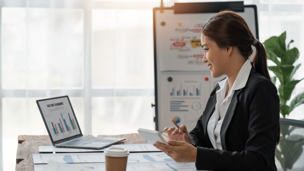 Business professional reviewing financial charts and planning cash allocations to support Profit First target percentages.